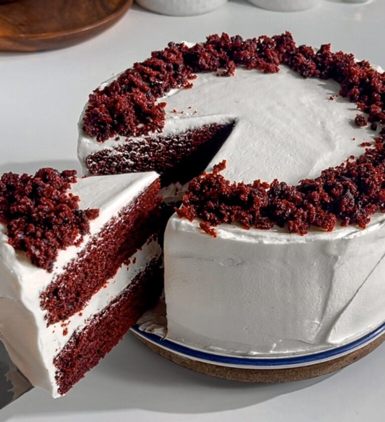 Slice of eggless red velvet cake showing soft and tender crumb