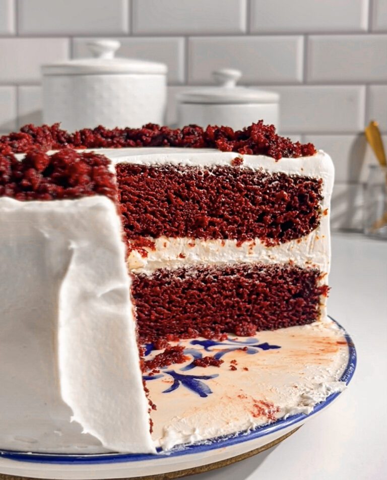 Moist eggless red velvet cake topped with smooth cream cheese frosting