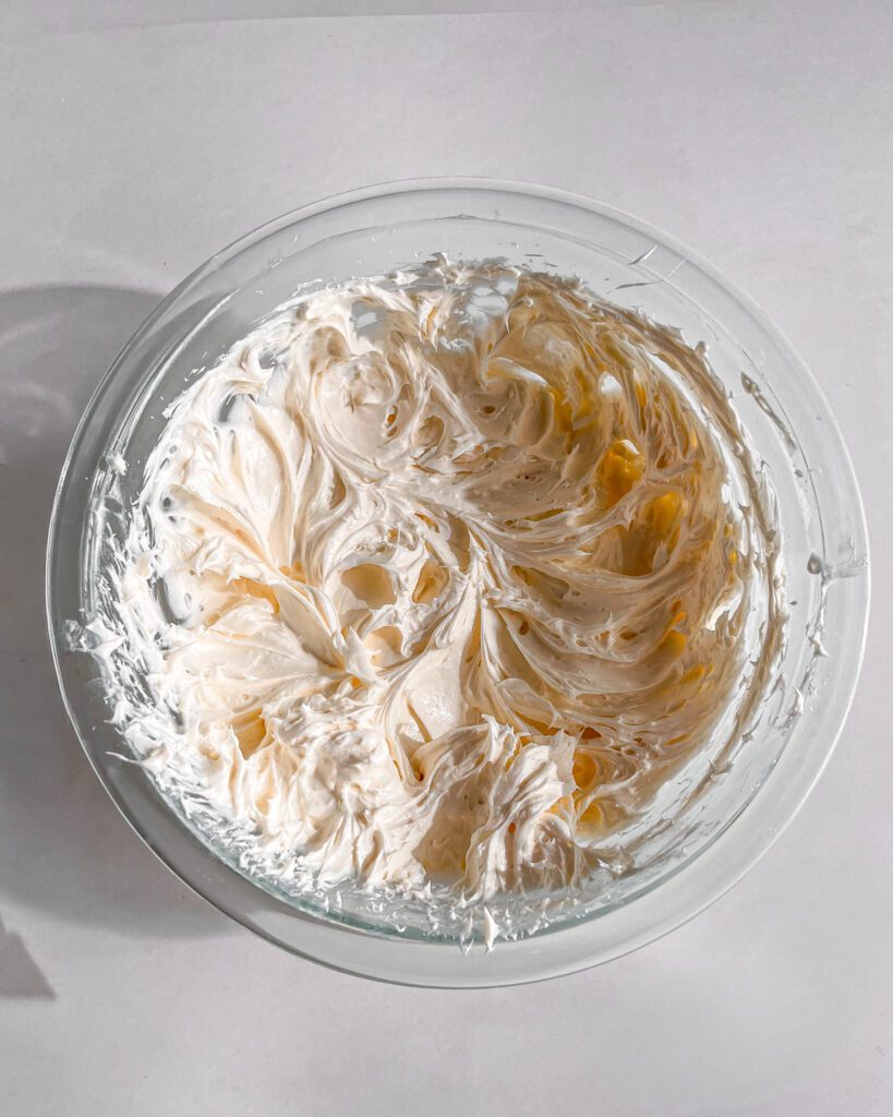 beating cream cheese frosting until smooth
