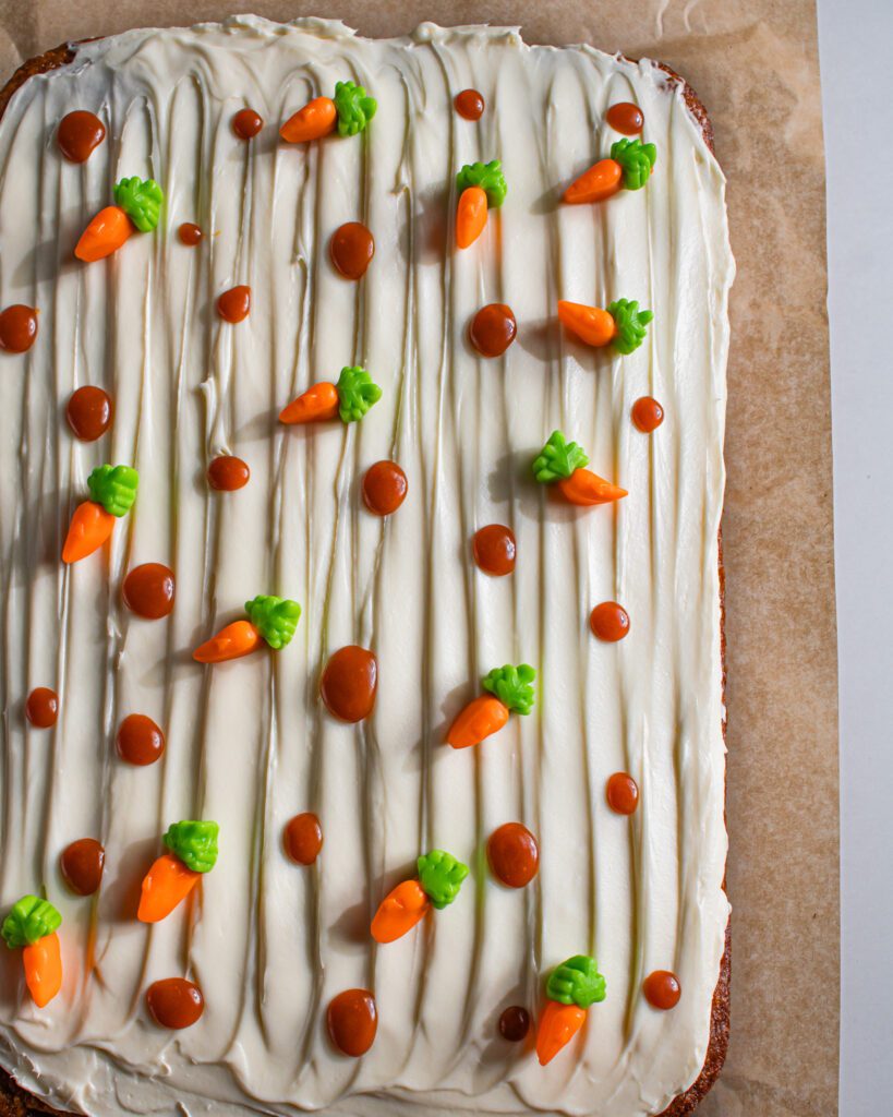 vegan eggfree carrot sheet cake topped with smooth frosting close up