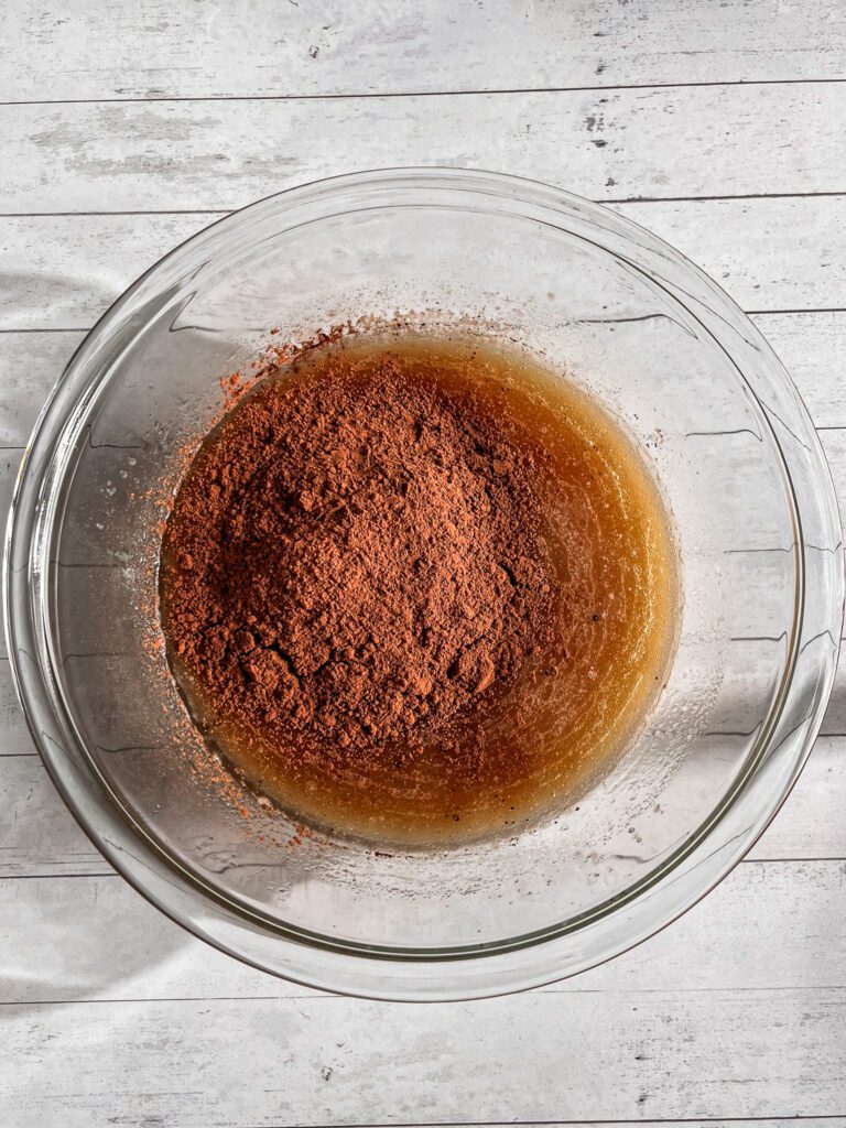 Adding cocoa powder to dry ingredients for eggless chocolate cupcakes