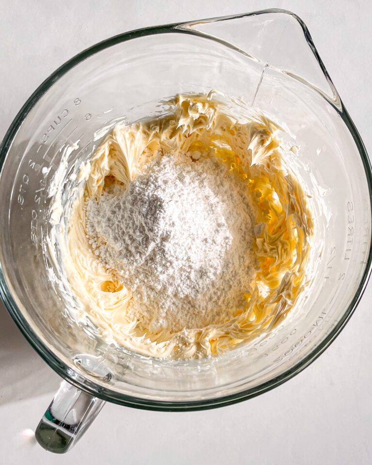Adding powdered sugar and cocoa powder to whipped butter
