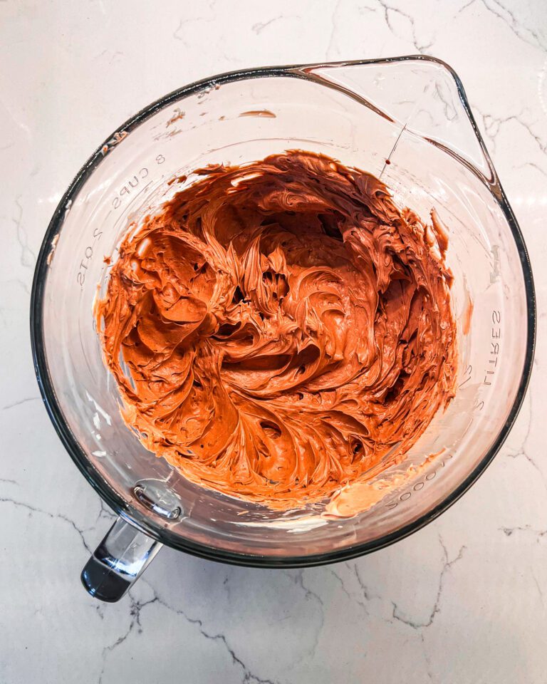 Chocolate buttercream frosting being prepared in a bowl