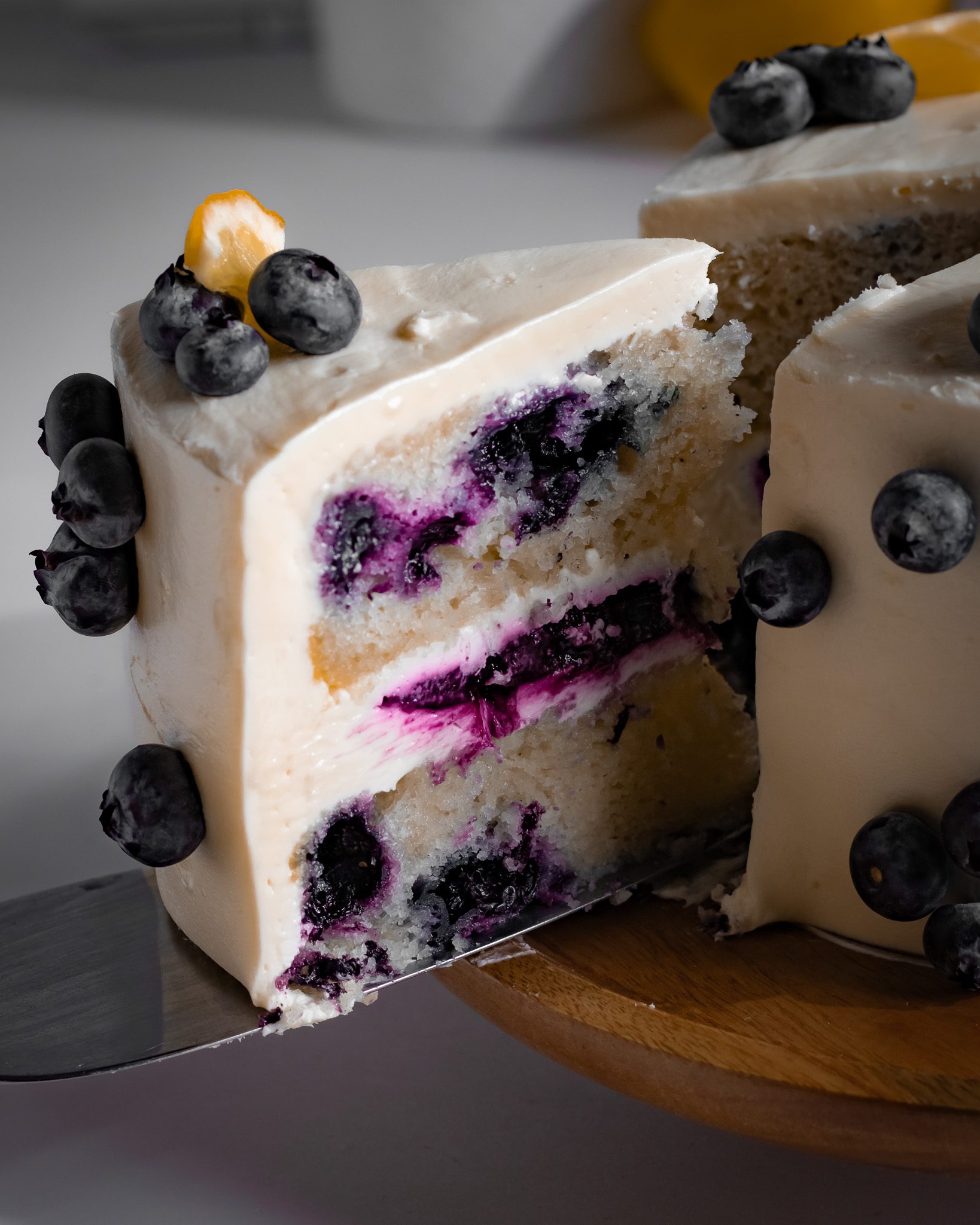 Eggless blueberry cake slice showing moist texture and berries