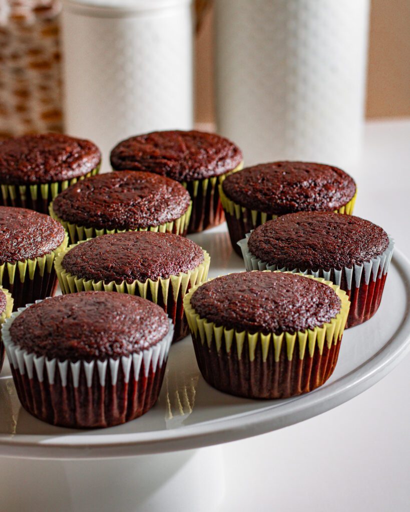 Freshly baked eggless dairy-free chocolate cupcakes cooling