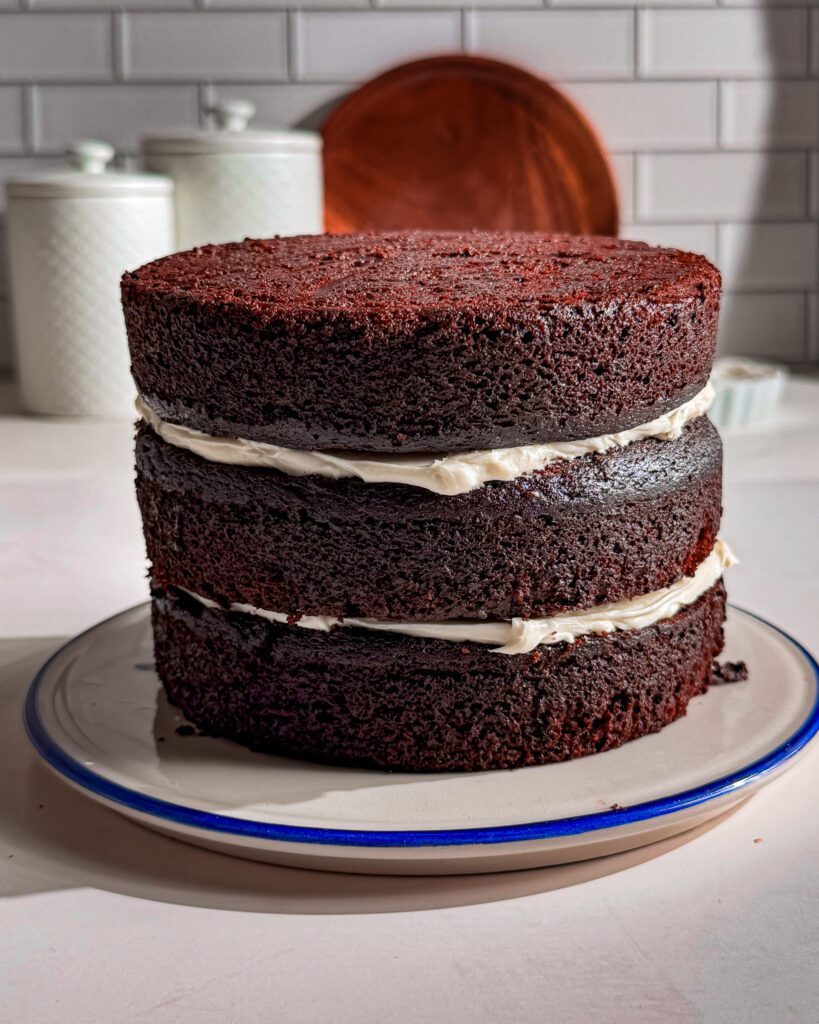 Frosting eggless chocolate layer cake with offset spatula jpg