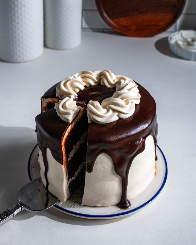Moist eggless chocolate layer cake with chocolate drip topping