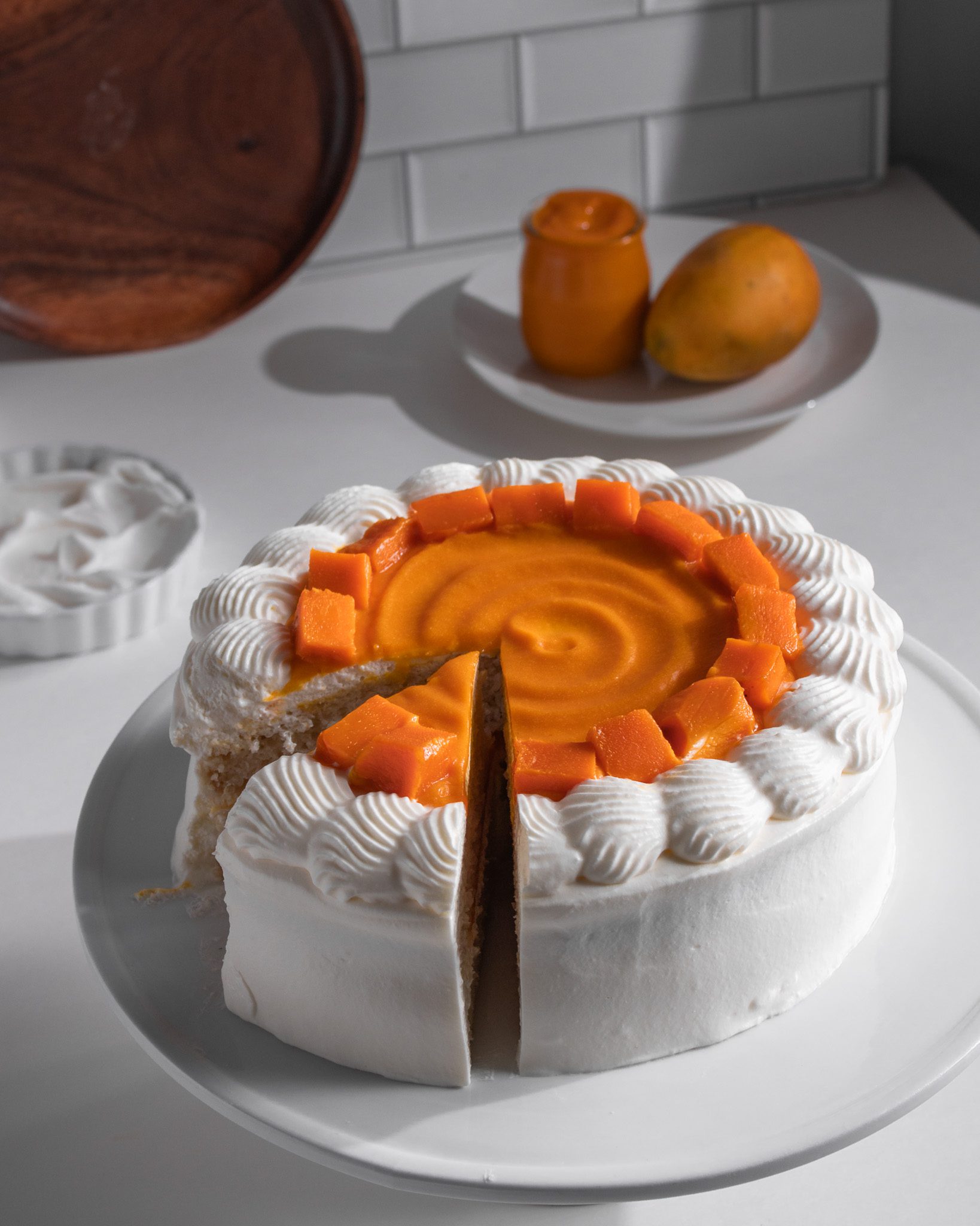 Moist eggless mango cake with fresh cream and mangoes