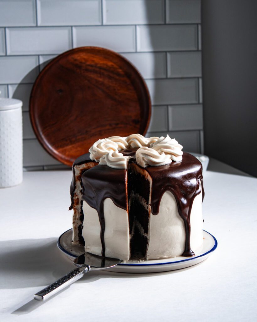 Serving homemade eggless chocolate cake with fudge glaze