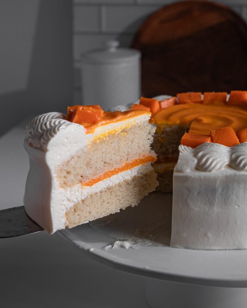 Slice of korean mango cream cake on dessert plate