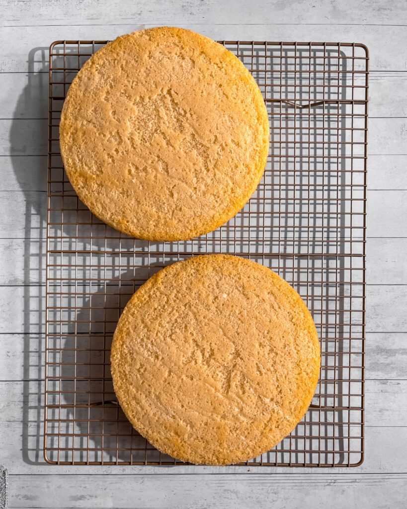 Soft eggless cake layers cooling on wire rack