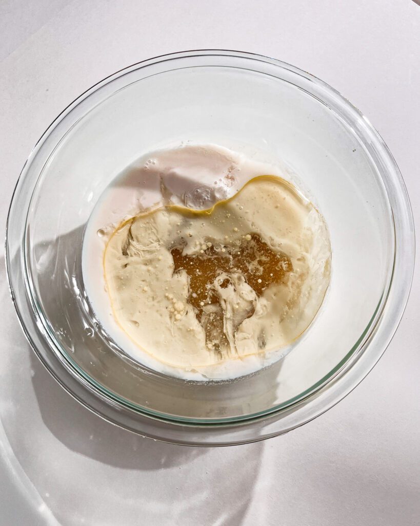 Wet ingredients being whisked for eggless cake recipe