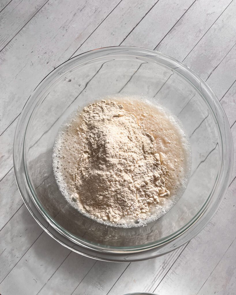 Dry ingredients being folded into wet mixture to form smooth batter