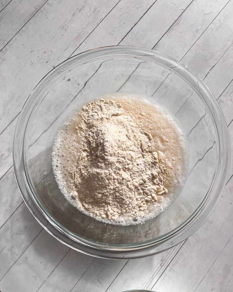 Dry ingredients being folded into wet mixture to form smooth batter for cinnamon coffee cake