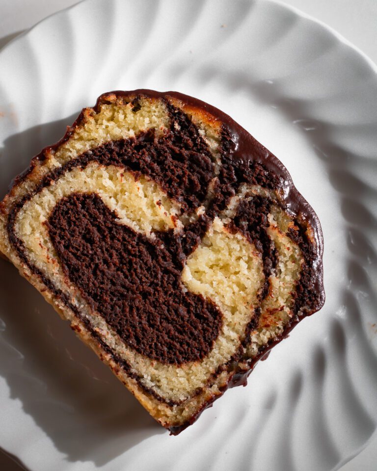 Soft vanilla and chocolate swirled vegan loaf cake served