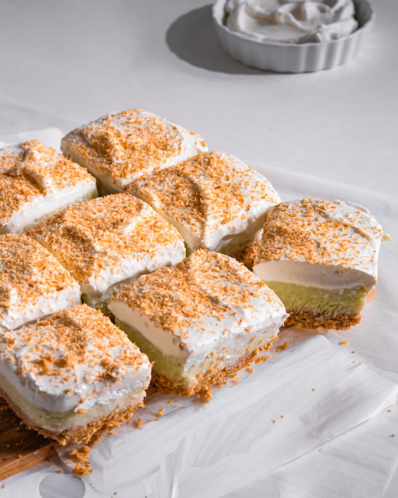 Homemade No-Bake Coconut Cream Pie Bars garnished with toasted coconut flakes.