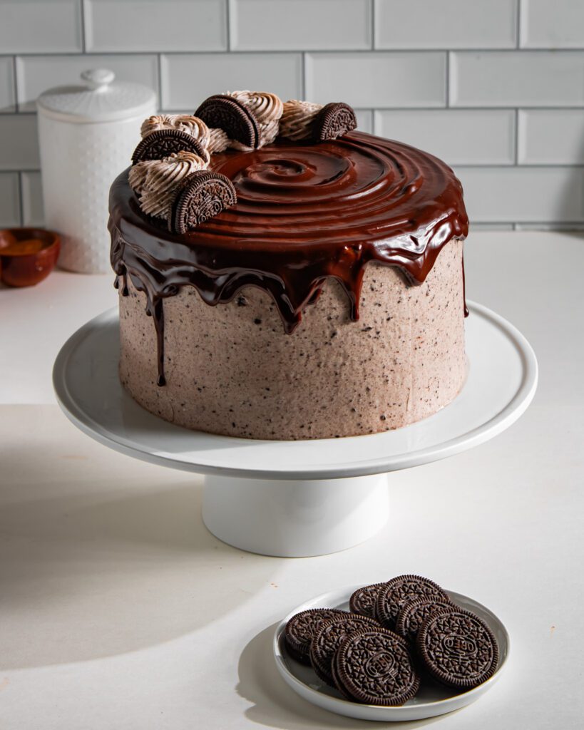 Rich Eggless Chocolate Cake layered with Oreo whipped cream cheese frosting.