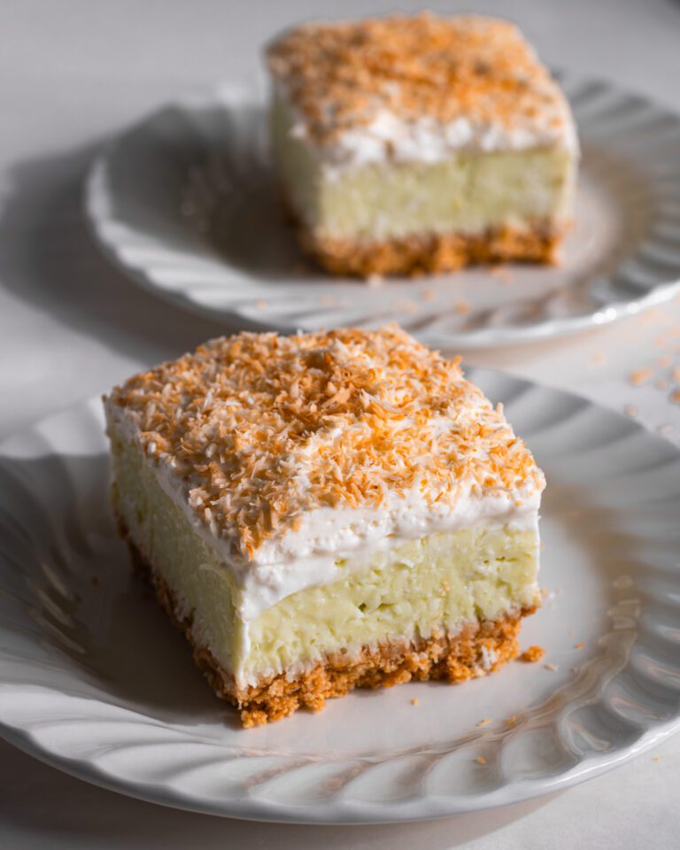 Slice of eggless No-Bake Coconut Cream Pie Bar on a white dessert plate.