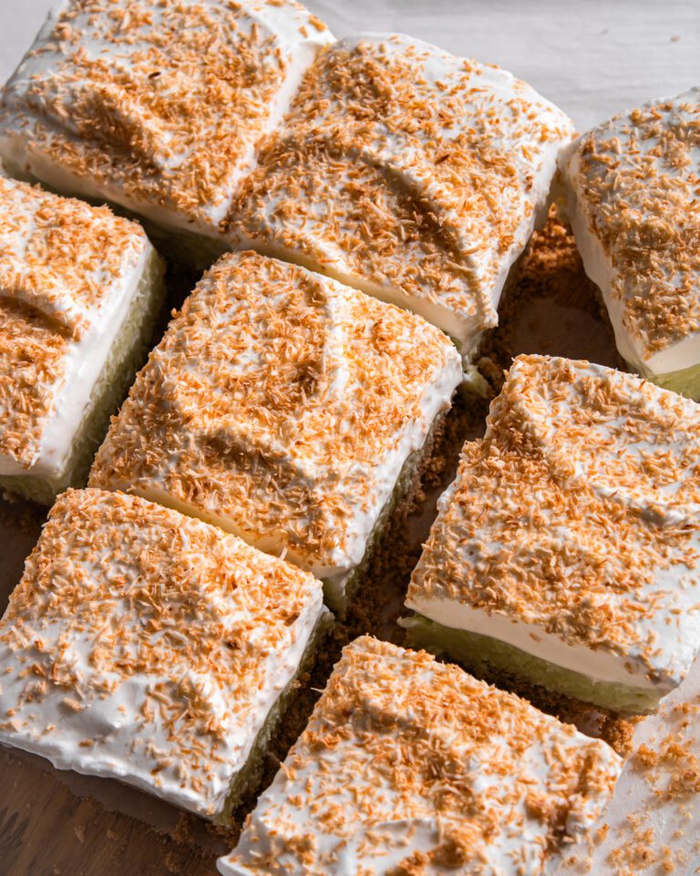 Slicing chilled No-Bake Coconut Cream Pie Bars into squares.