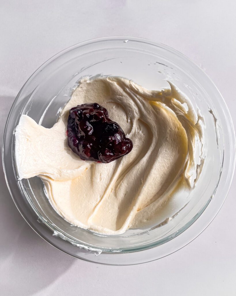 Adding blueberry jam to cream cheese frosting