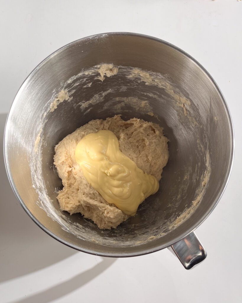 Adding butter to cinnamon roll dough