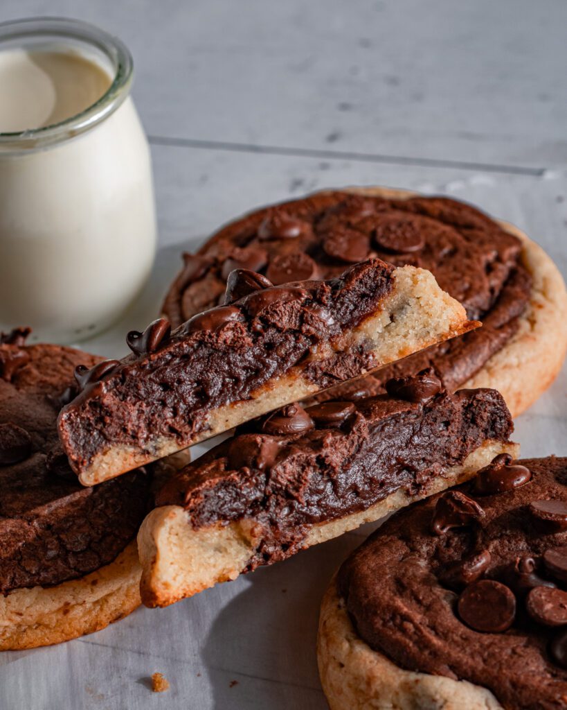 Chocolate brookie cookie broken open showing the chewy cookie center
