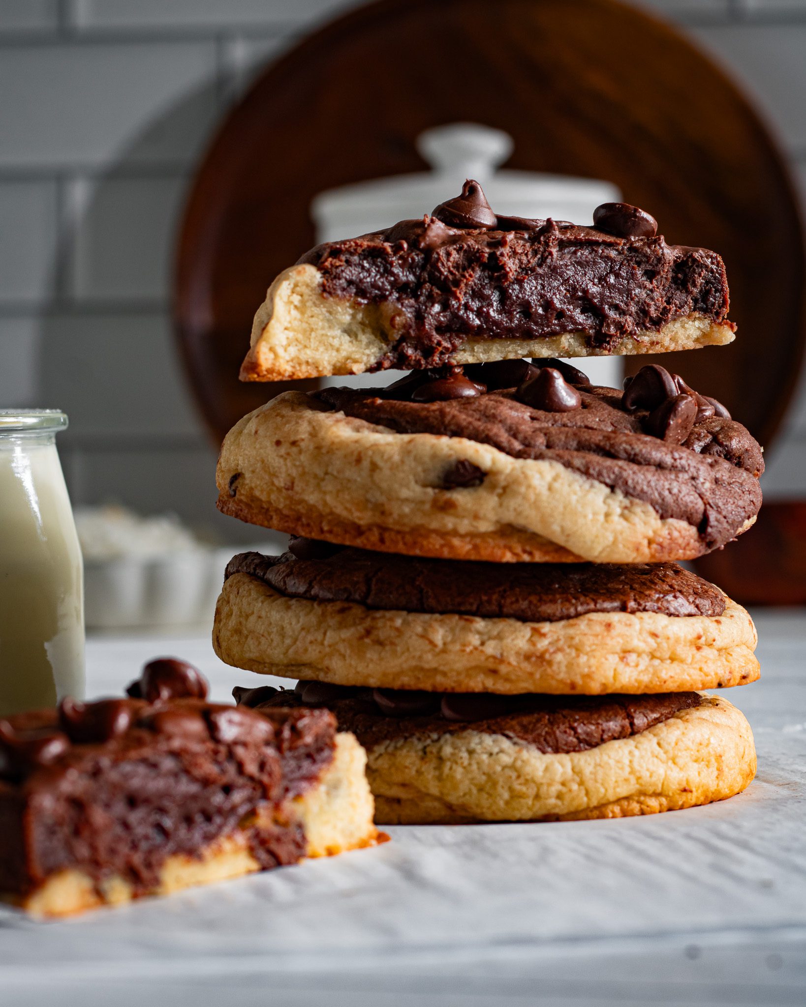 Chocolate brookie cookie broken open showing the chewy cookie center and fudgy brownie layer
