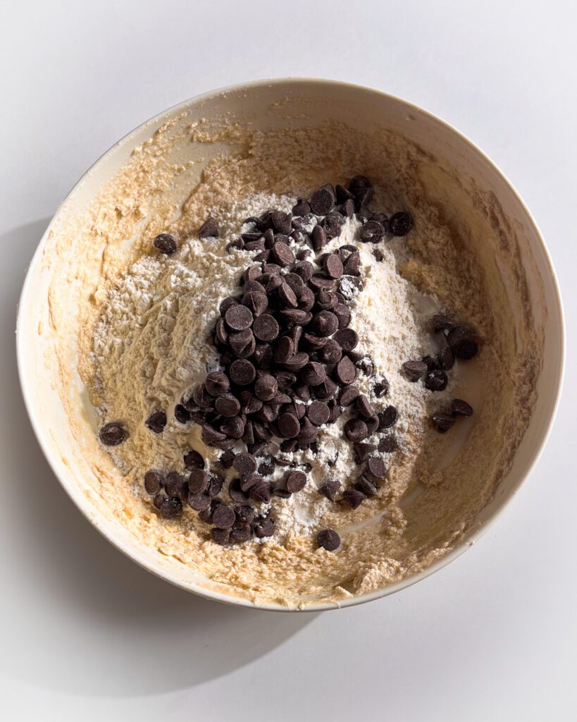 Chocolate chips folded into eggless cookie dough