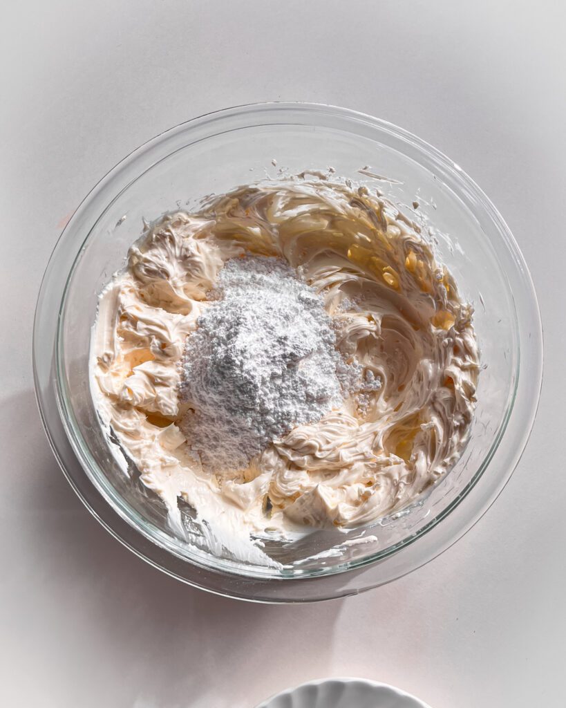 Mixing cream cheese and powdered sugar for coconut filling