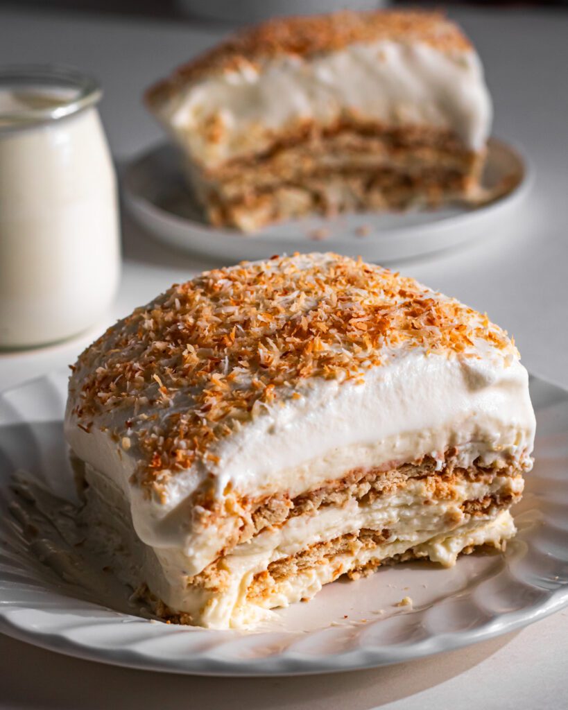 Slice of creamy No-Bake Coconut Icebox Biscuit Cake