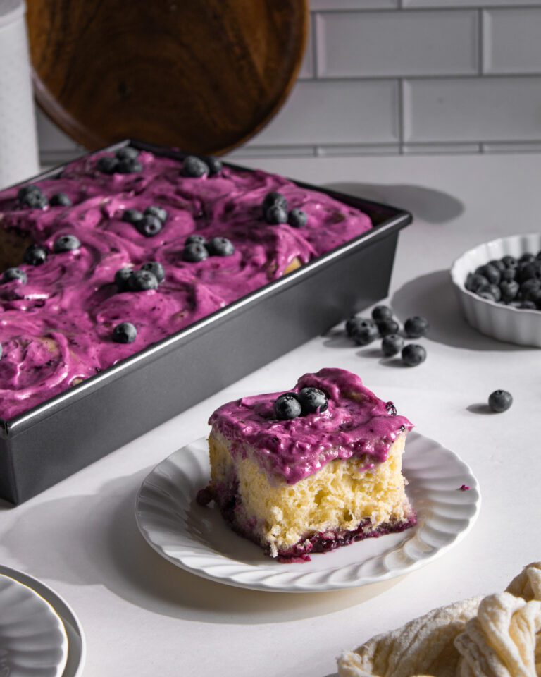 Soft and gooey eggless blueberry cinnamon rolls on a plate