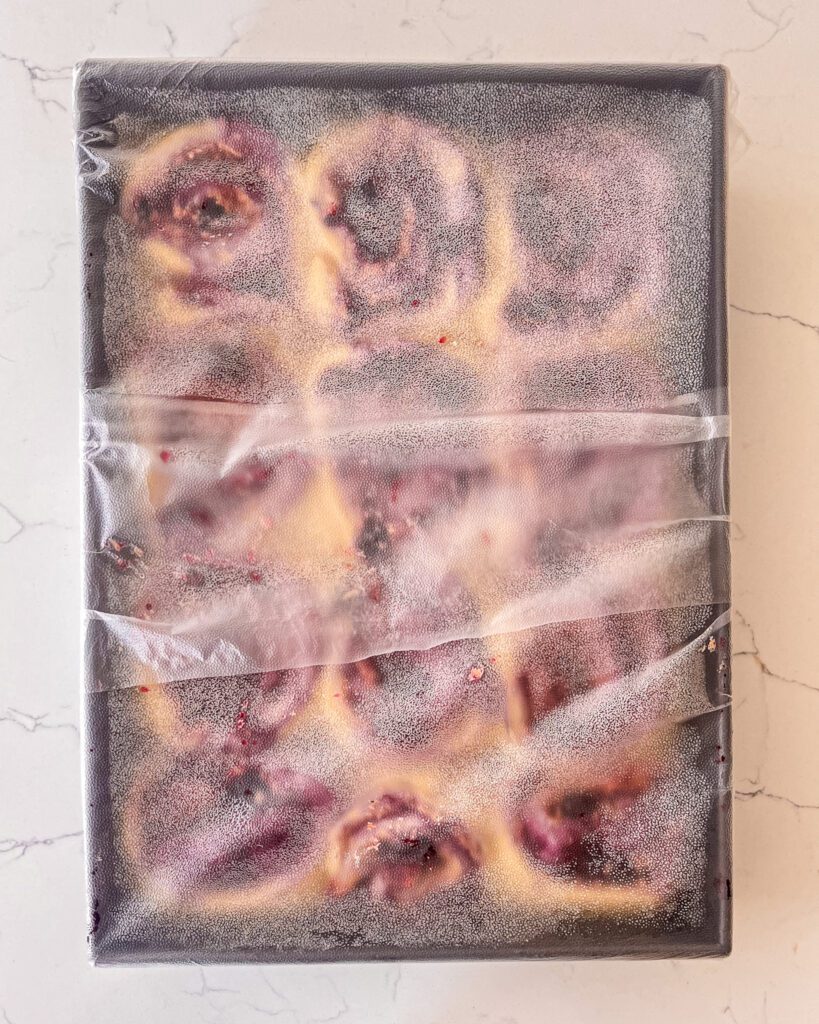 blueberry cinnamon rolls in a baking pan for overnight proofing