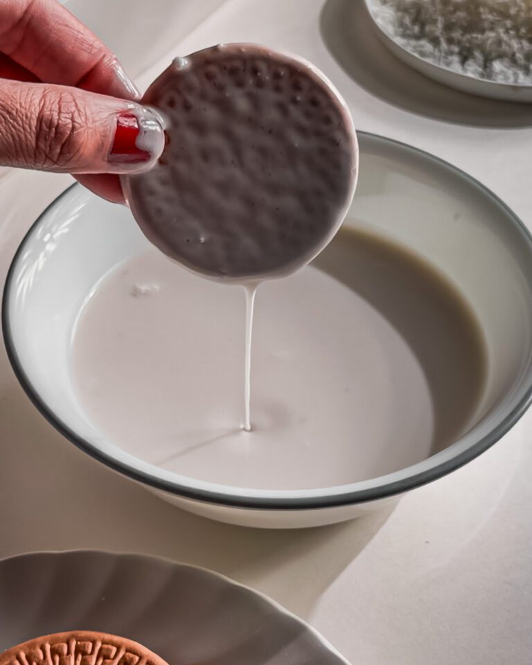 soaking biscuits in coconut milk for layering icebox cake