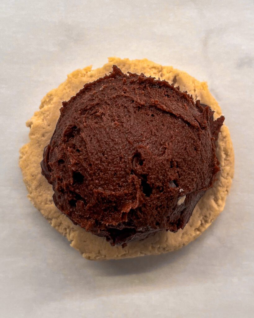 Brownie batter placed in the center of cookie dough