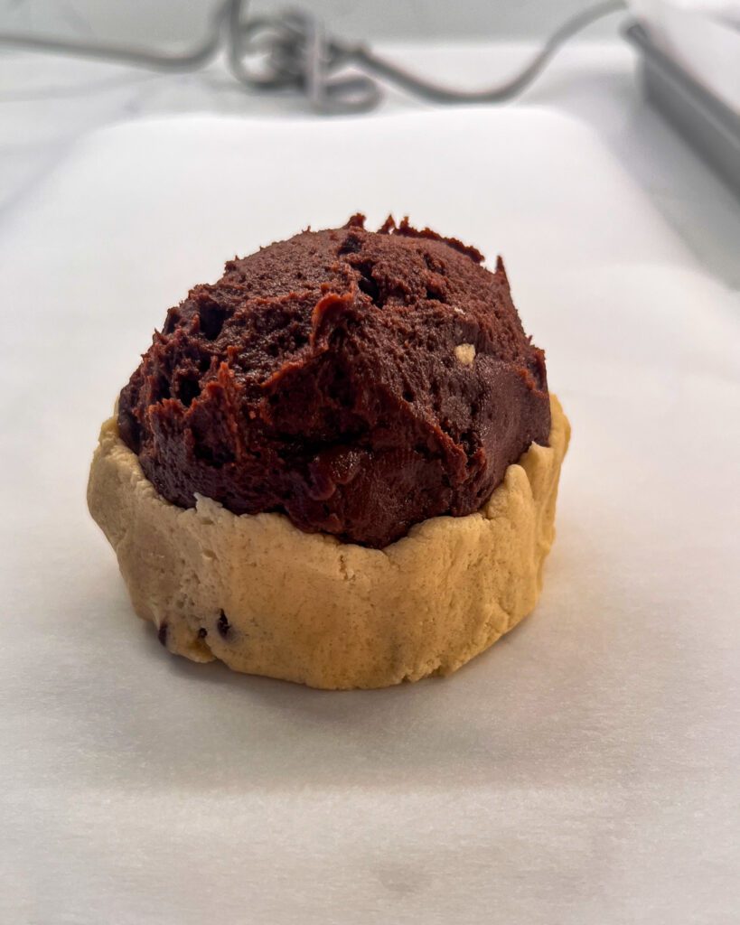 Sealing the cookie dough around the brownie center