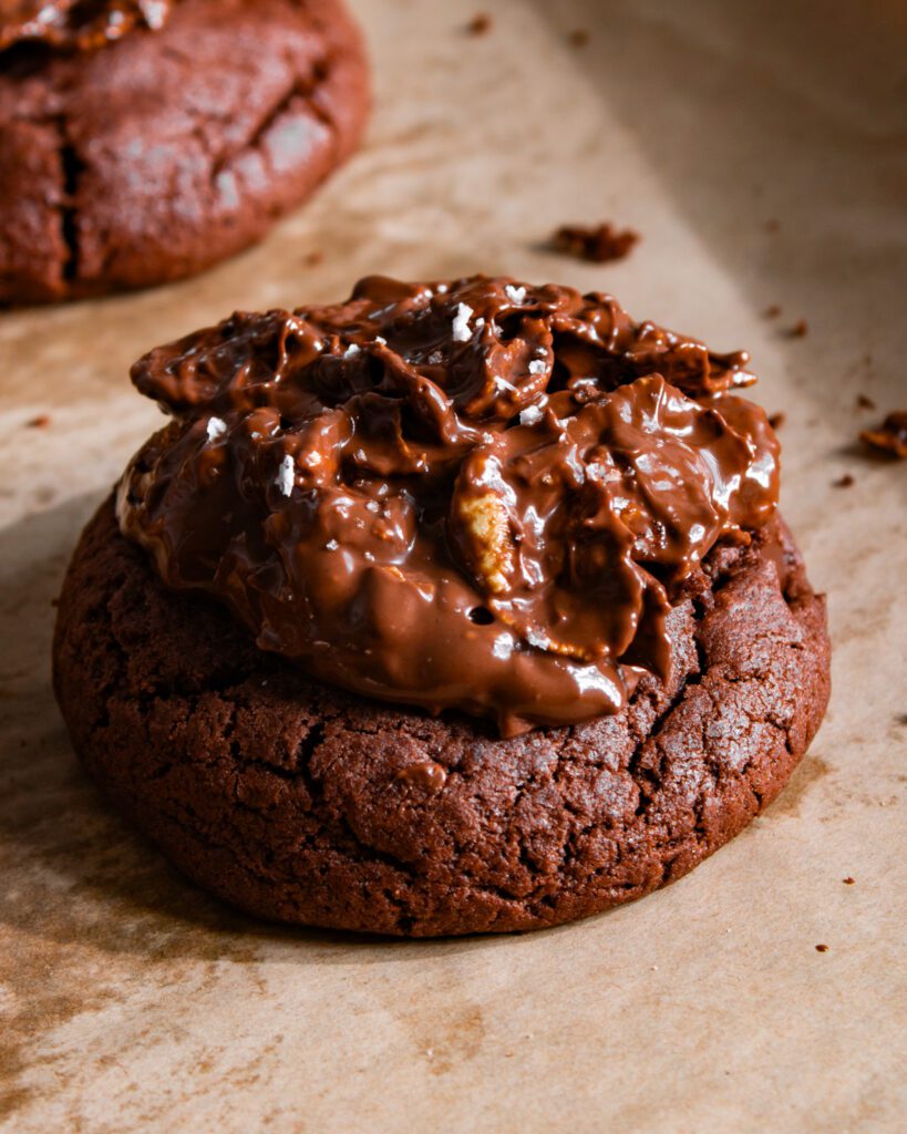 Sprinkling sea salt over chocolate crunch cookies
