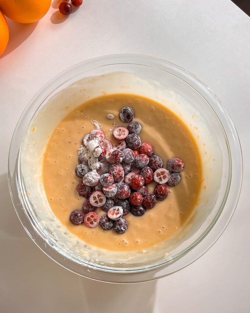 Fresh cranberries folded into orange loaf cake batter