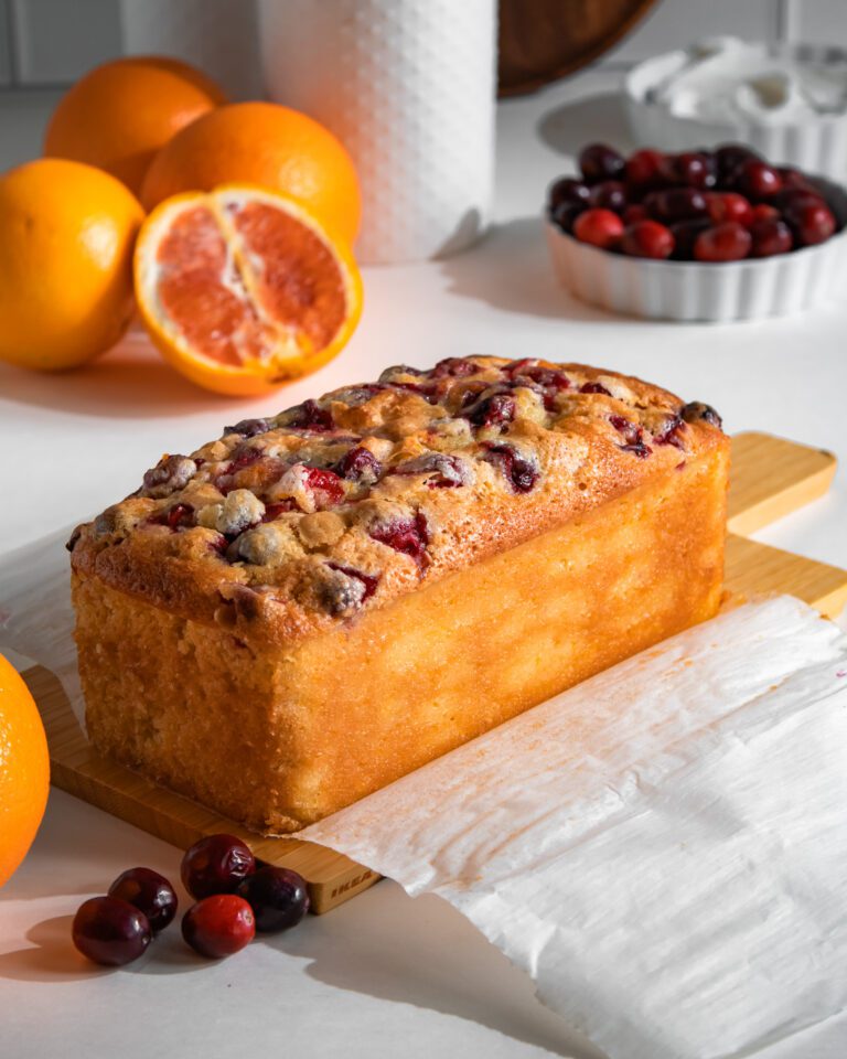 Golden orange cranberry loaf cake freshly baked in a loaf pan
