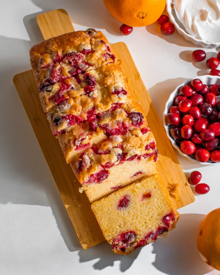 orange cranberry loaf-cake slices on board