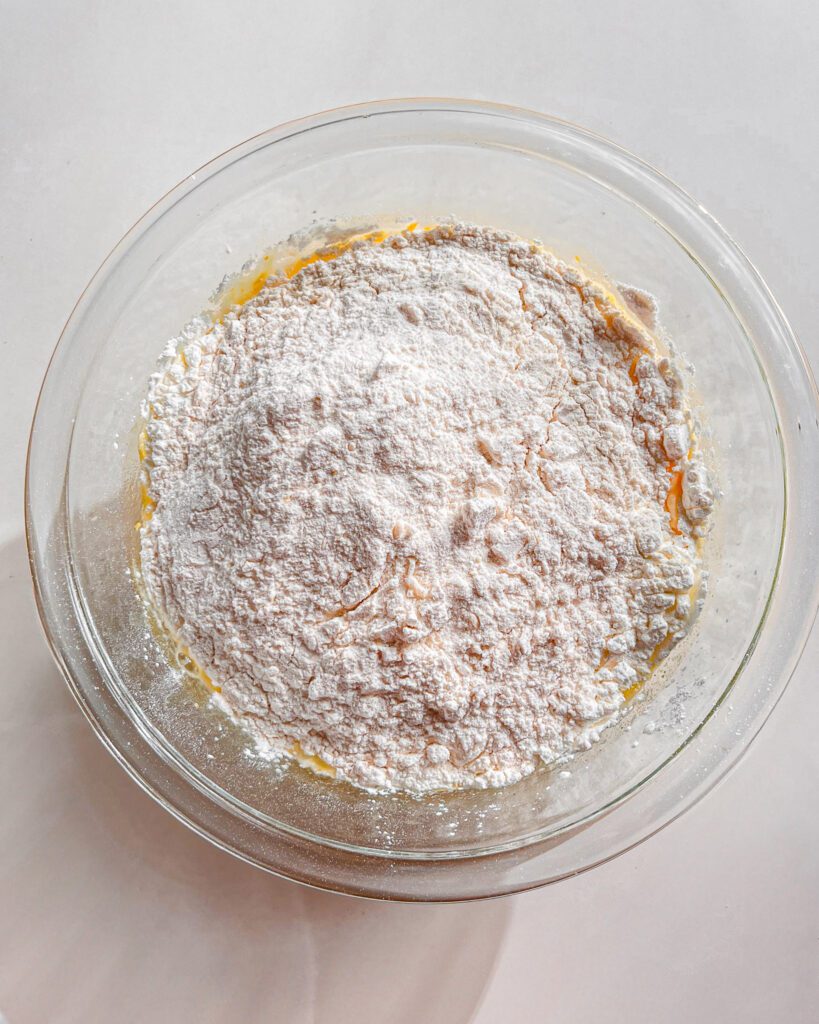 Flour, baking powder, baking soda, and salt whisked together for orange cranberry cake