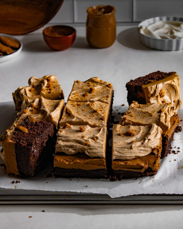Square pieces of chocolate Biscoff cake topped with Biscoff buttercream
